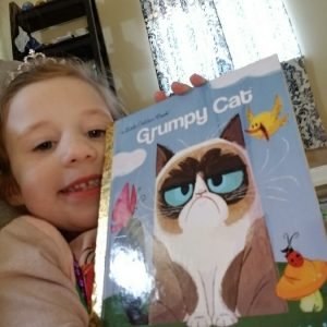 Kaylee reading the Grumpy cat that wouldn't