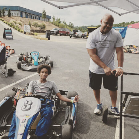 Sit down between Tony and Antonio, a father and son racing team